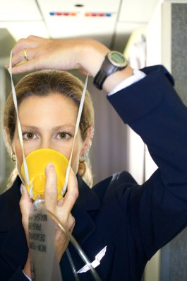 Flight Attendant with an Oxygen Mask